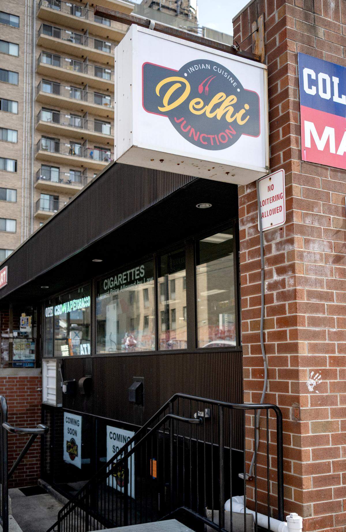 Signs promoting Delhi Junction hang at 128 Locust Lane, which is below College Mart on Thursday, March 14, 2024.
