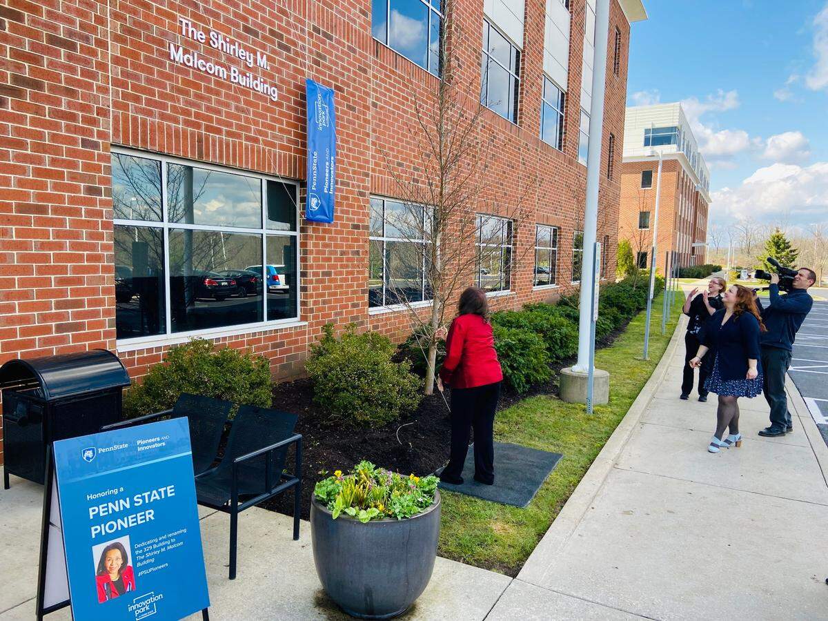 Shirley Malcom pulls down a banner at 329 Building in Innovation Park on Friday, revealing the building’s new name: The Shirley M. Malcom Building.