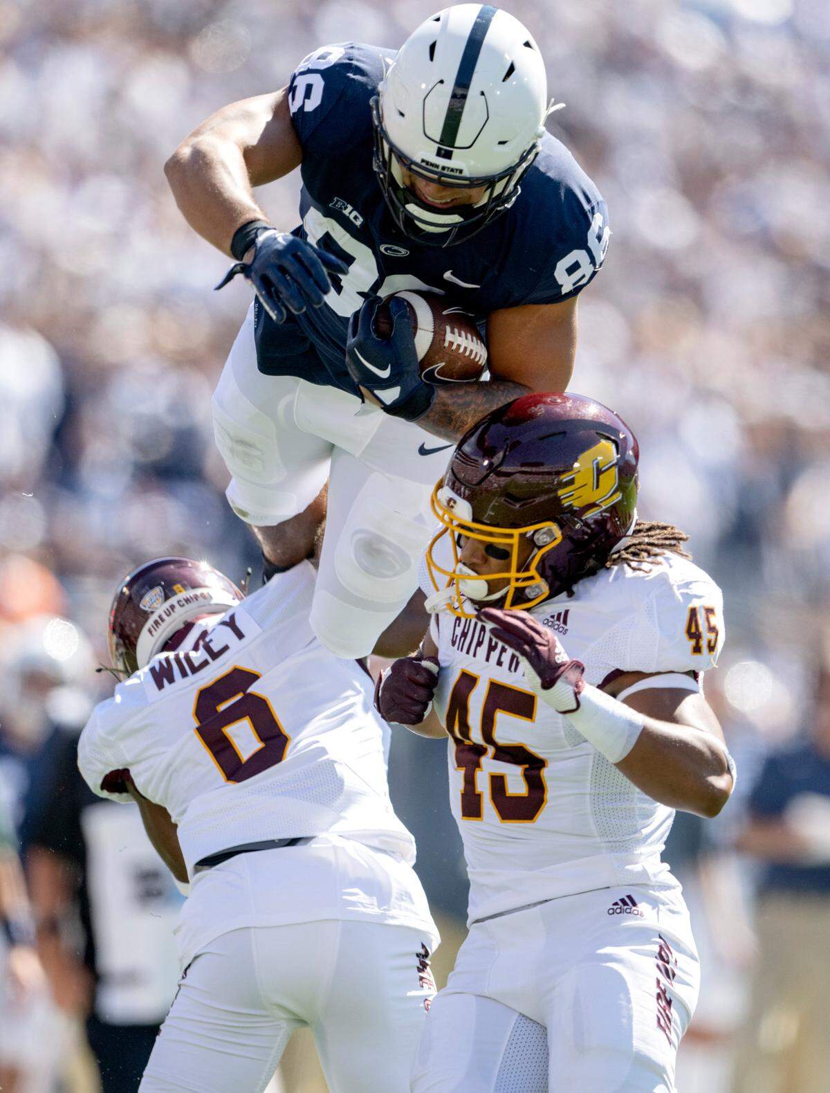 Penn State tight end Brenton Strange tries to leap over Central Michigan defenders during the game on Saturday, Sept. 24, 2022.