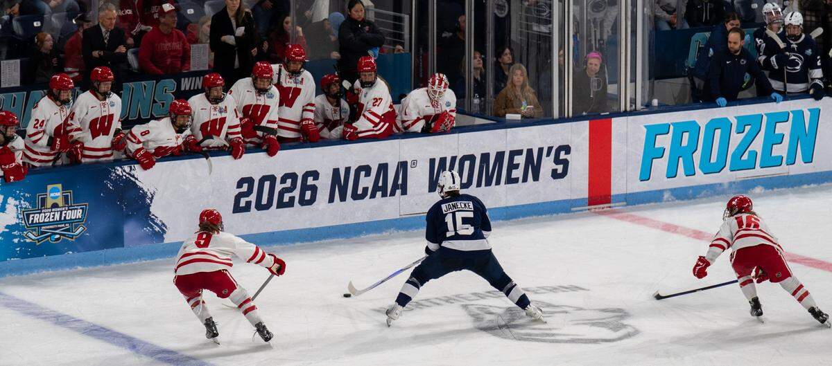 Penn State forward Tessa Janecke  maneuvers the puck around Wisconsin players during the women’s hockey Frozen Four game in Pegula Ice Arena on Friday, March 20, 2026. 
