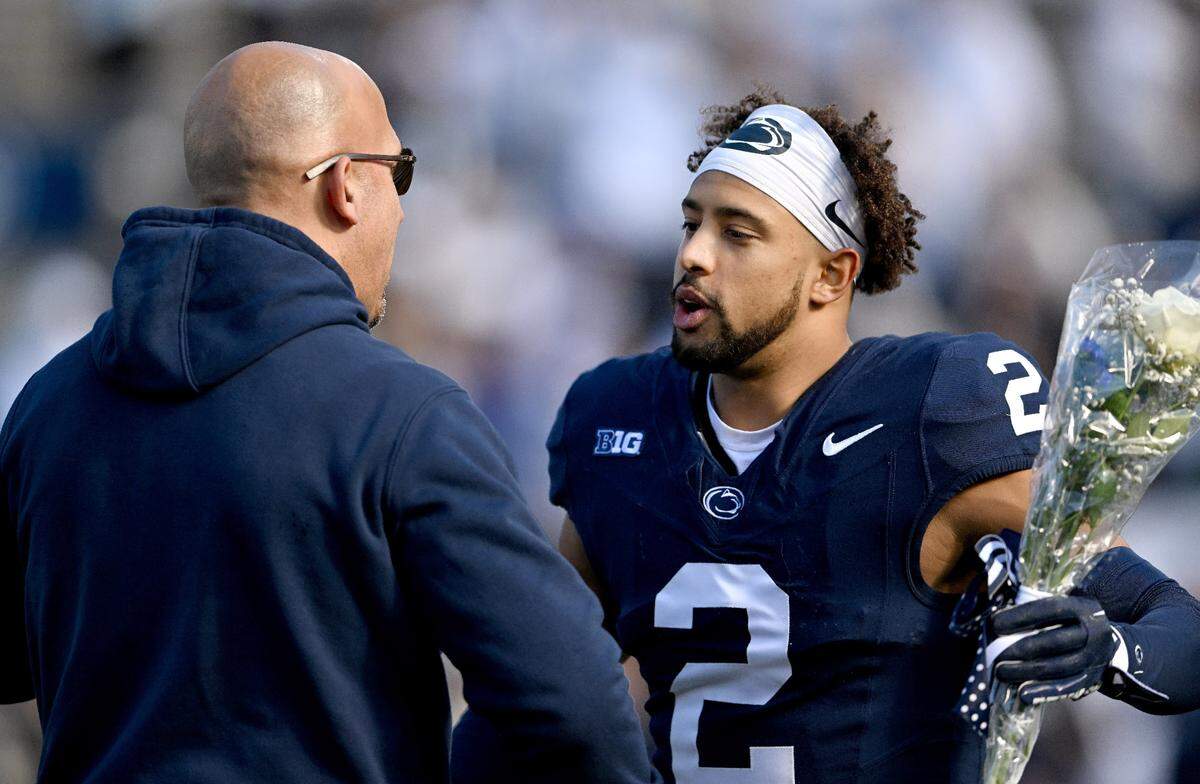 Penn State football coach James Franklin greets safety Keaton Ellis as part of the Senior Day celebration before the game against Rutgers on Saturday, Nov. 18, 2023.