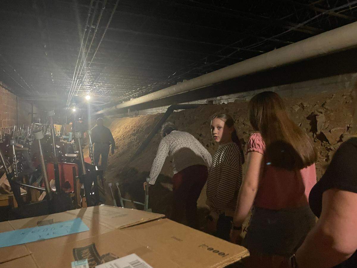 Community members file through Bellefonte Elementary’s “dirt cellar” as part of a guided behind-the-scenes tour on May 21, 2026.