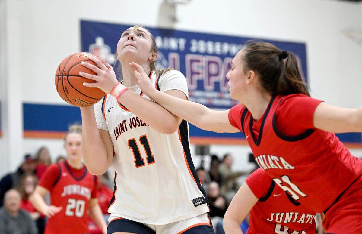 Saint Joseph’s Catholic Academy’s Aubrey Yartz looks to the basket around a Juniata defender during the game on Thursday, Jan. 23, 2025. Saint Joseph’s Catholic Academy won, 72-34.