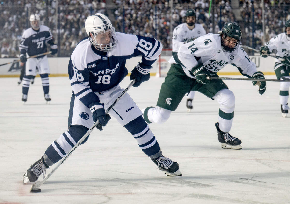 Penn State's Aiden Fink skates with the puck ahead of Michigan State defenders during the game at Beaver Stadium on Saturday, Jan. 31, 2026.