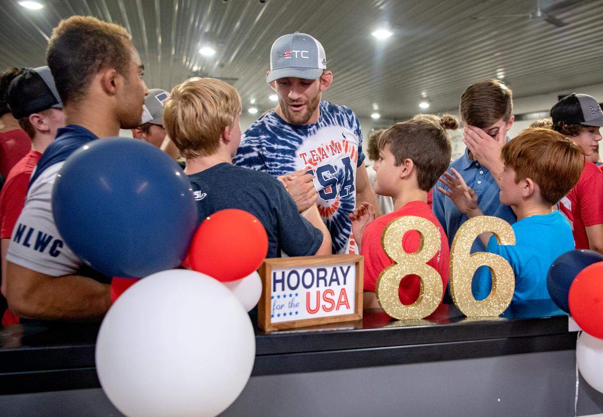 Wrestlers from M2 Training Center welcome home their coach and gold medal Olympian David Taylor on Thursday, Aug. 12, 2021.
