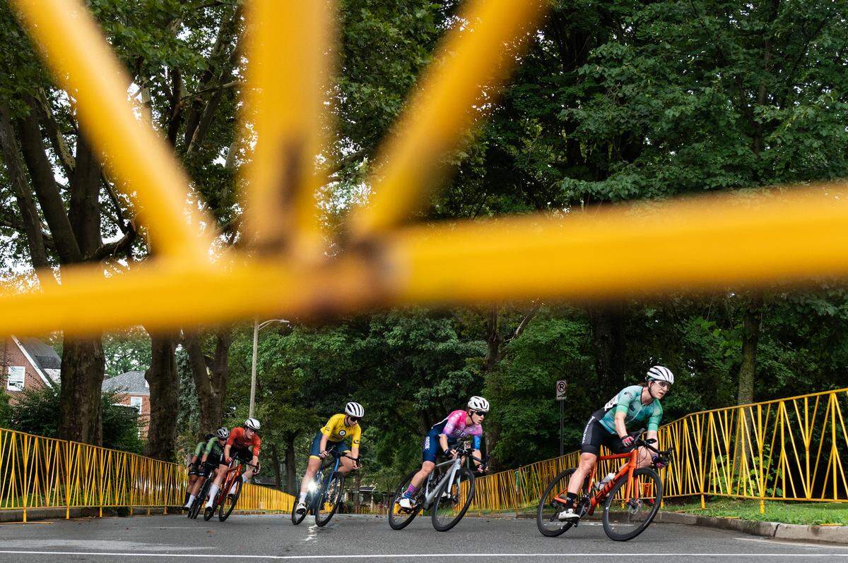 Women’s Cat 1, Cat 2 and Cat 3 cyclists race around a corner during the State College Criterium on Saturday, July 26, 2025 in State College, Pa.