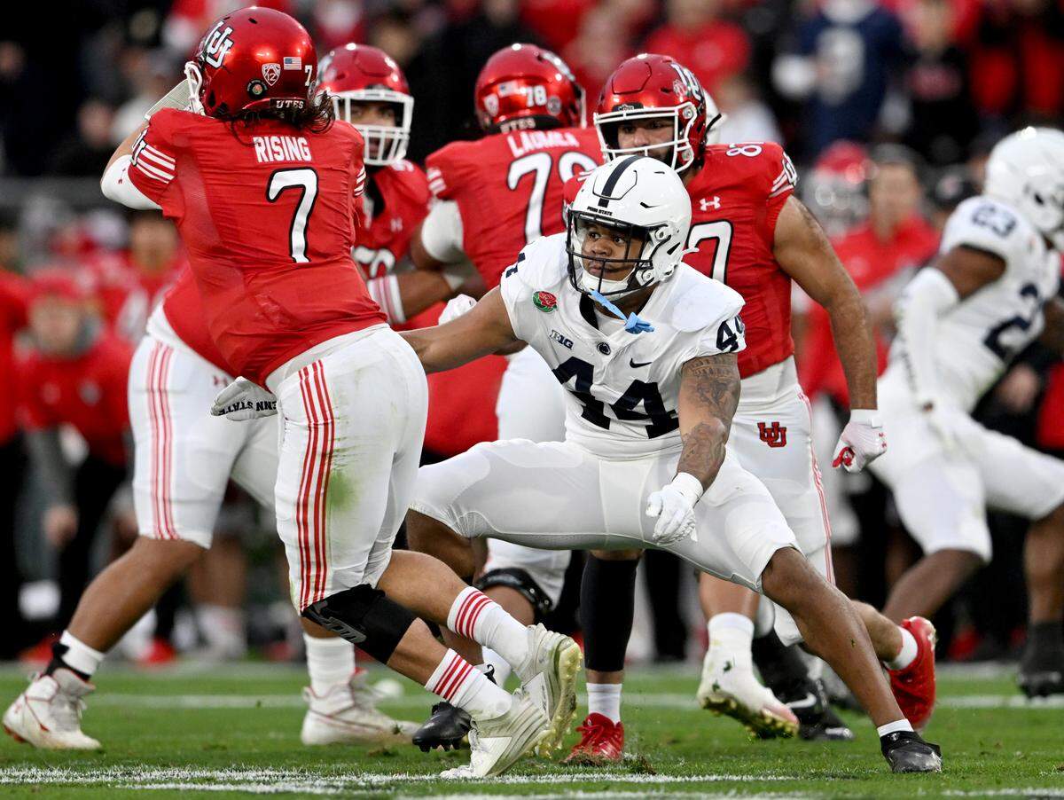 Penn State defensive end Chop Robinson reaches for Utah’s Cam Rising during the Rose Bowl game on Monday, Jan. 2, 2023.