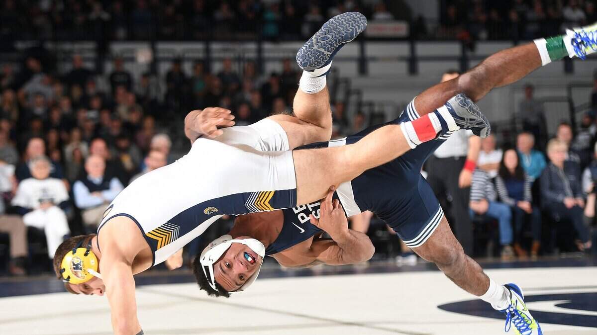 Penn State’s Mark Hall, 174 lbs, (bottom) takes down Kent State’s Dylan Barreiro enroute to a pin Sunday at Rec Hall in State College. Penn State defeated Kent State, 52-3. (For the CDT/Steve Manuel)