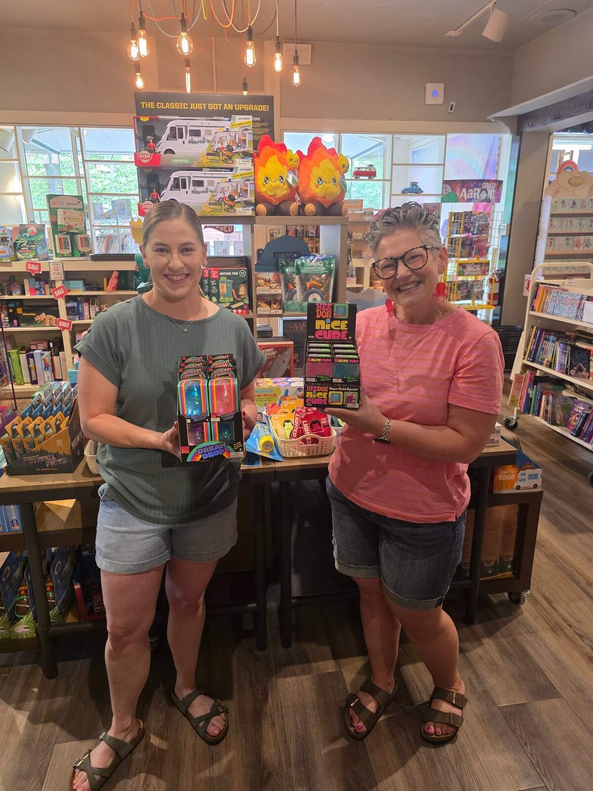 Growing Tree Toys employee Lindsay Jones, left, and store manager Jen Heller pose with their limited NeeDoh stock.
