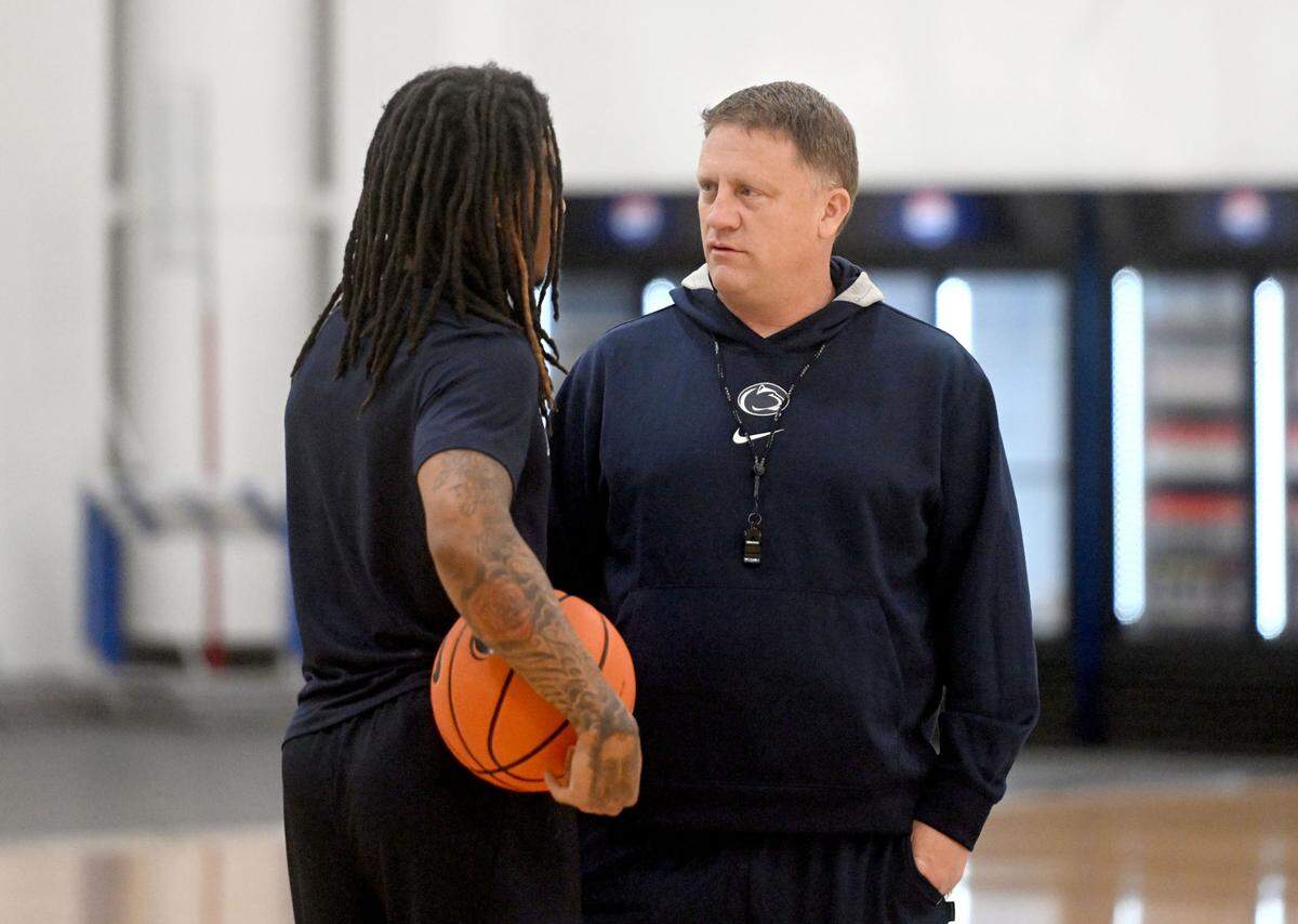 Penn State men’s basketball coach Mike Rhoades talks to Ace Baldwin Jr. before the start of a summer practice on Thursday, July 18, 2024.