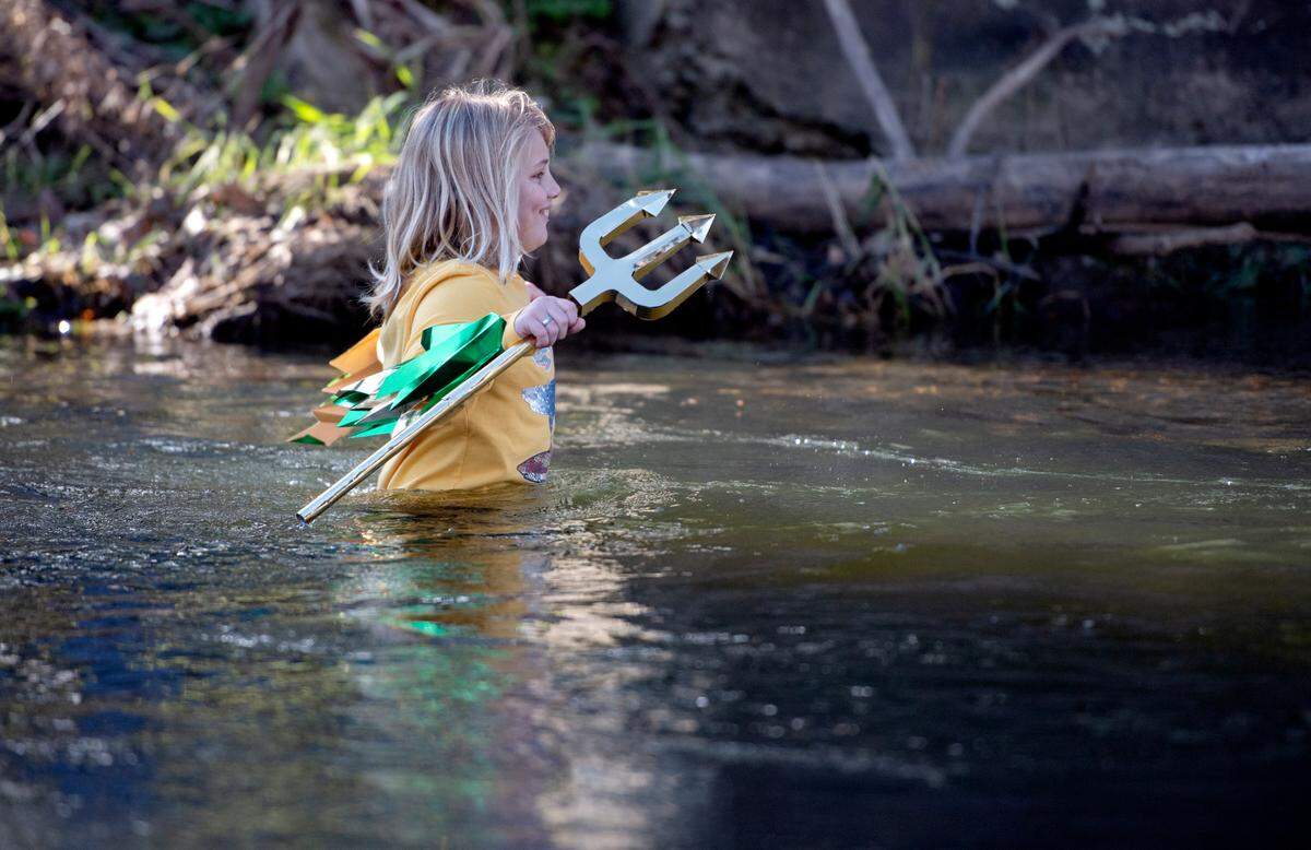 Bodhi Tennis, 11, wades into Penns Creek before diving underwater for the YMCA of Centre County Polar Bear Plunge on Saturday.