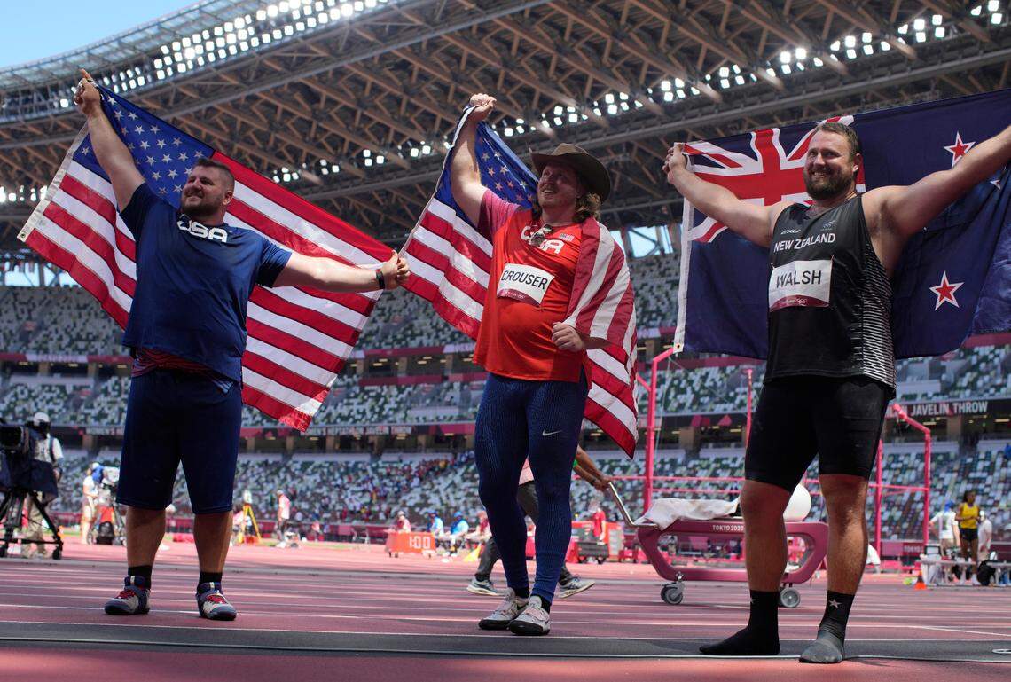 Ryan Crouser, of the United States, center, celebrates after winning the gold in the final of the men’s shot put with Joe Kovacs, of the United States, left, silver, and Tomas Walsh, of New Zealand, bronze, at the 2020 Summer Olympics, Thursday, Aug. 5, 2021, in Tokyo, Japan.