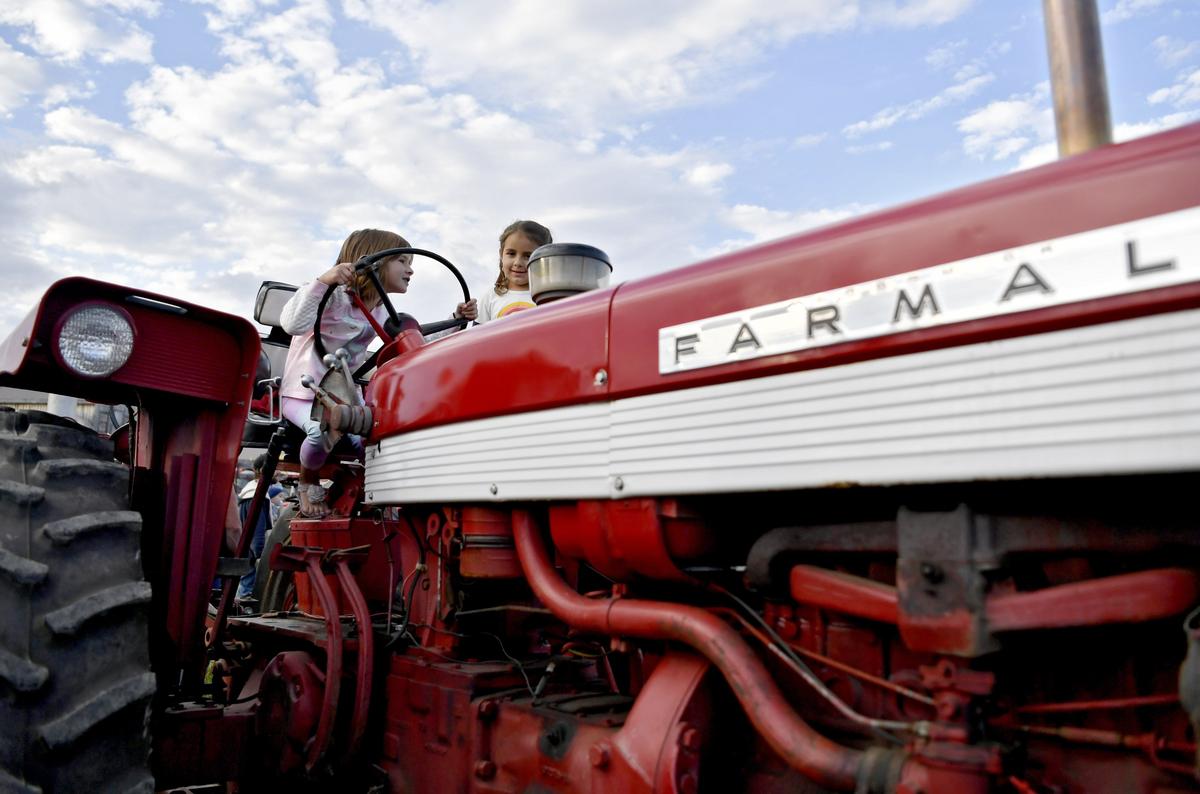 Andrea Neese, 5, and Lia Ritter, 6, play on Andrea’s grandfathers tractors at the Nittany Antique Machinery Association fall show on Friday, Sept. 6, 2019 at Penns Cave.