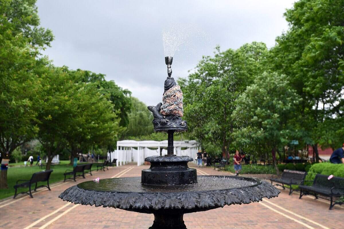 Yarn is wrapped around a fountain as part of a yarn bombing installation Saturday in Bellefonte.