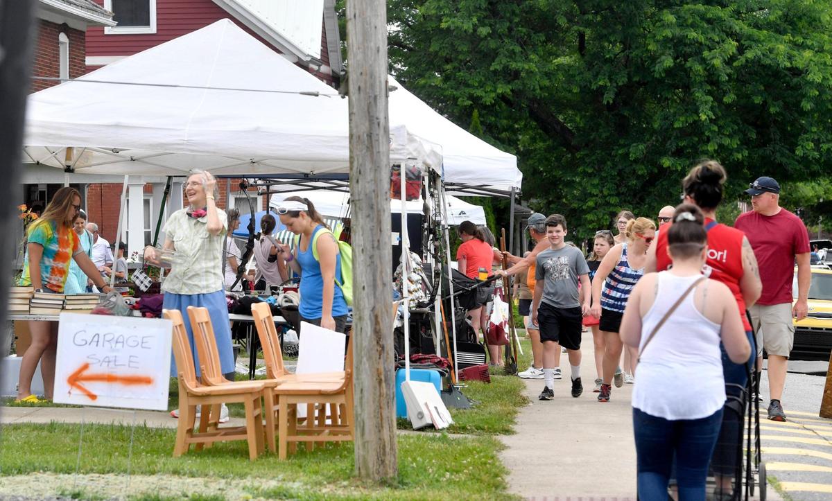 Shoppers walk along Pennsylvania Avenue in Centre Hall for the annual town-wide yard sale on Friday, June 26, 2020.