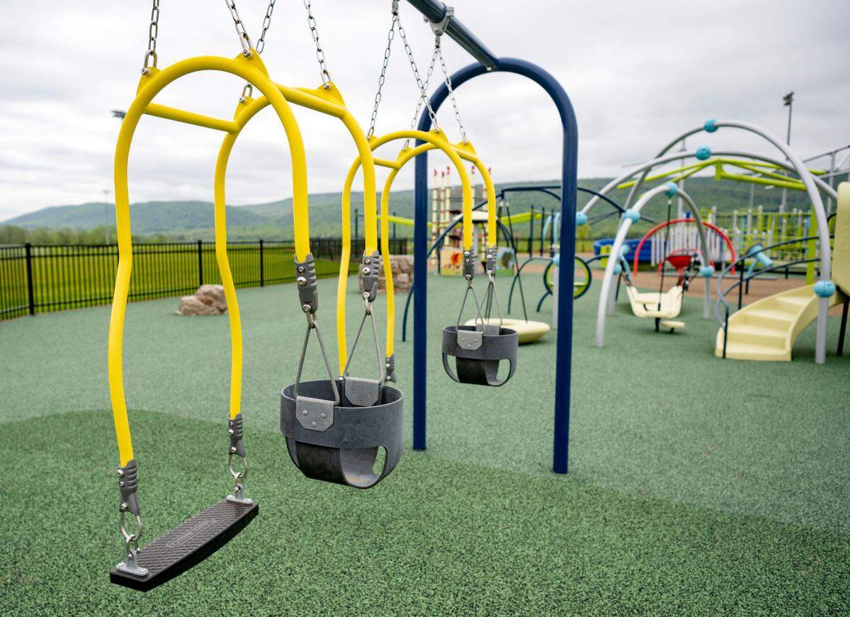 Swings for an adult and a child to swing together at the all-abilities playground at Whitehall Road Regional Park on Tuesday, May 7, 2024. The park officially opened on July 25, 2025.