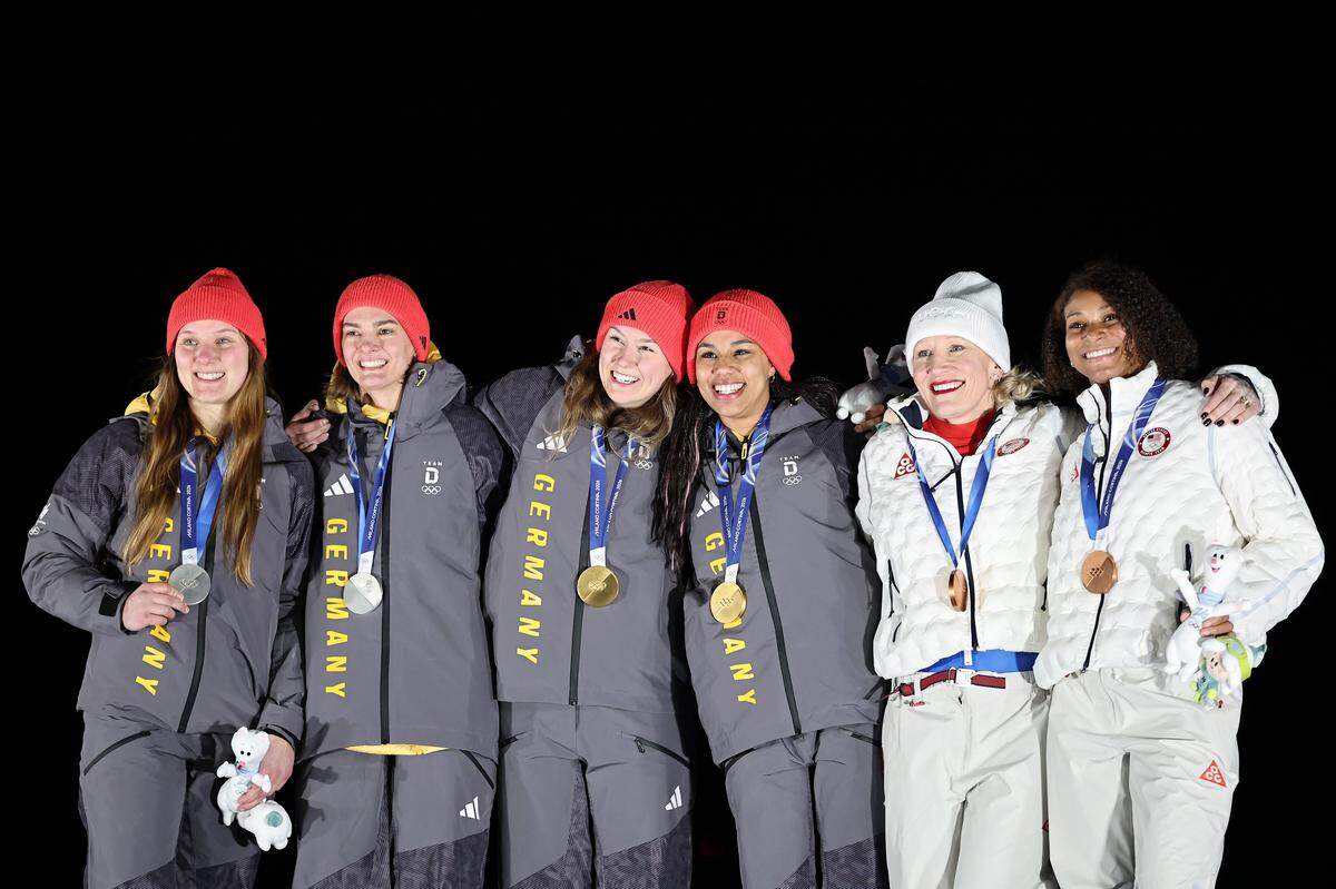 CORTINA D'AMPEZZO, ITALY - FEBRUARY 21: Gold medalists Laura Nolte and Deborah Levi of Team Germany, Silver medalists Lisa Buckwitz and Neele Schuten of Team Germany and Bronze medalists Kaillie Armbruster Humphries and Jasmine Jones of Team United States pose on the podium during the medal ceremony for the Bobsleigh Two-Woman on day fifteen of the Milano Cortina 2026 Winter Olympic games at Cortina Sliding Centre on February 21, 2026 in Cortina d'Ampezzo, Italy. (Photo by Carmen Mandato/Getty Images)