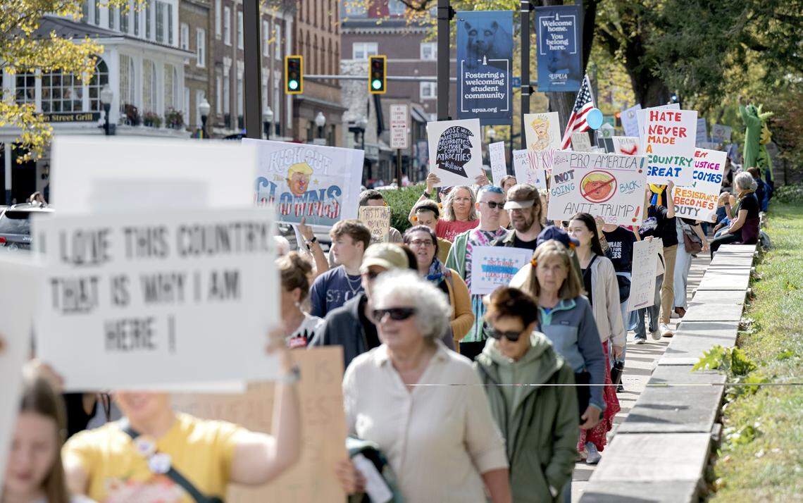 Protesters marched on the sidewalks along College Avenue  as part of the No Kings anti-Trump rally on Saturday, Oct. 18, 2025. 