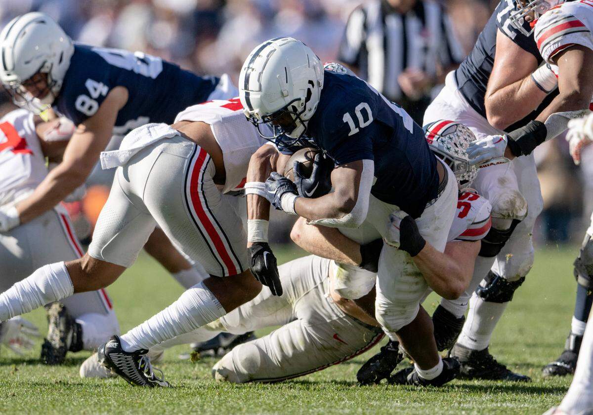 Ohio State defenders stop Penn State running back Nick Singleton during the game on Saturday, Oct. 29, 2022.