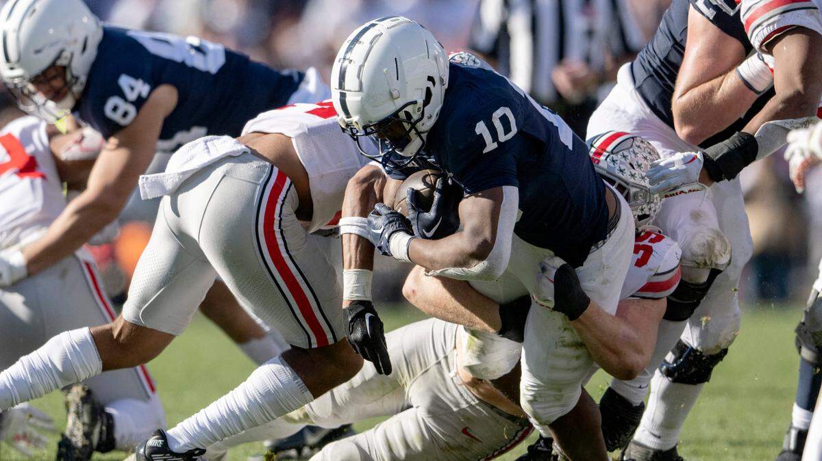 Ohio State defenders stop Penn State running back Nick Singleton during the game on Saturday, Oct. 29, 2022.