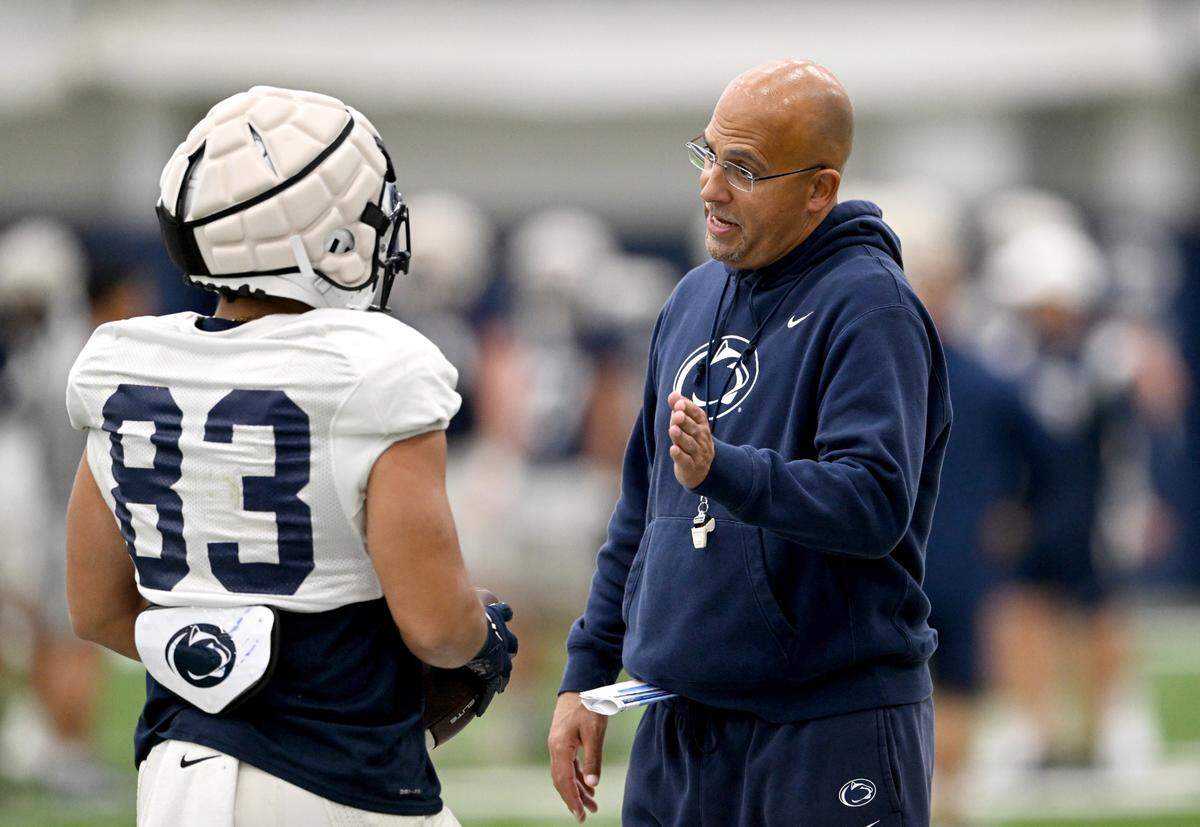 Penn State football coach James Franklin talks to wide receiver Jake Spencer during practice on Tuesday.