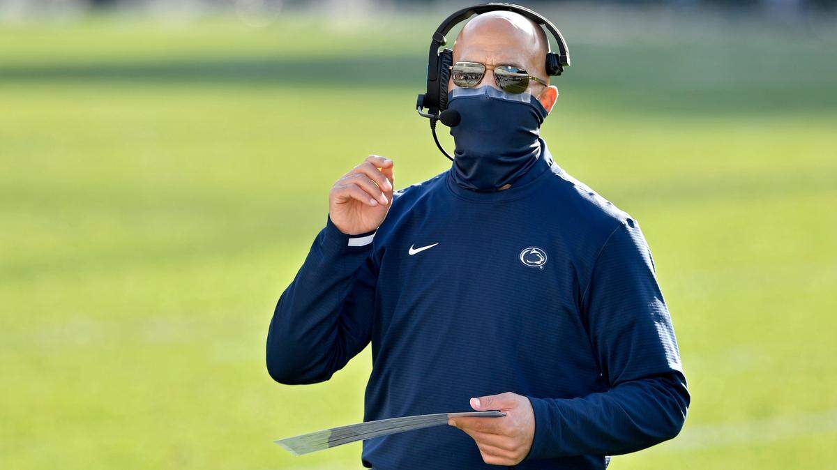 Penn State football coach James Franklin talks on his headset as he comes off the field during the game against Michigan State on Saturday, Dec. 12, 2020 at Beaver Stadium.
