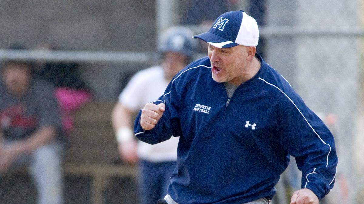 Philipsburg-Osceola softball coach Jim Gonder celebrates as the Mounties tie the score at in seventh inning of a Thursday, April 10, 2014 game against Central.