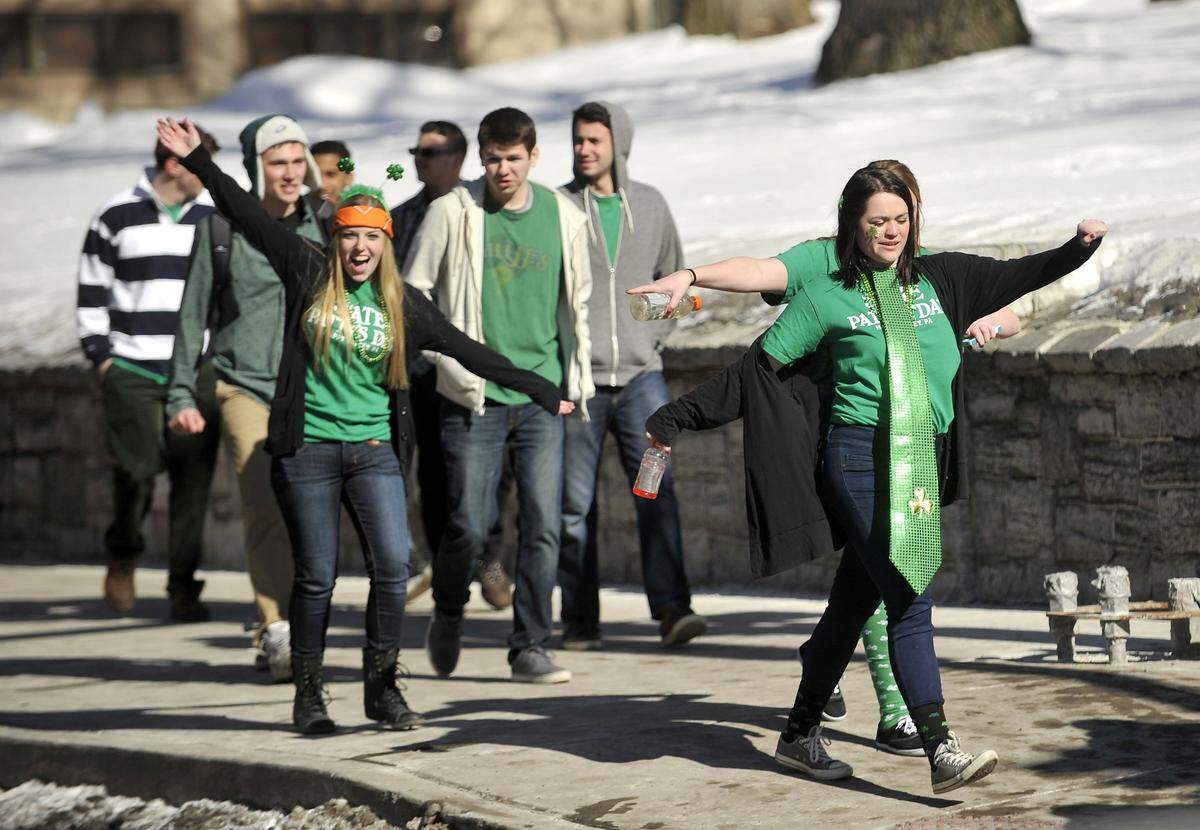 Pedestrians walk along Beaver Avenue wearing State Patty's Day shirts in February 2015.