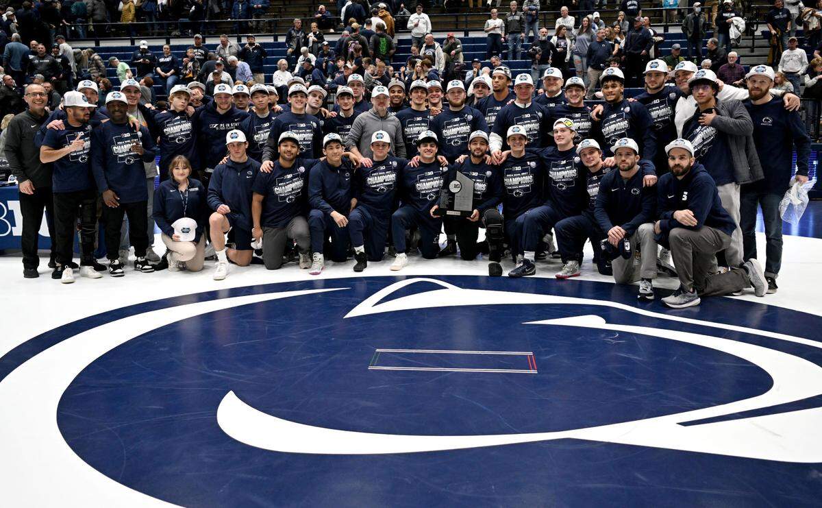 Penn State wrestling celebrates winning the Big Ten regular season title after the win over Nebraska on Sunday, Feb. 18, 2024 in Rec Hall.