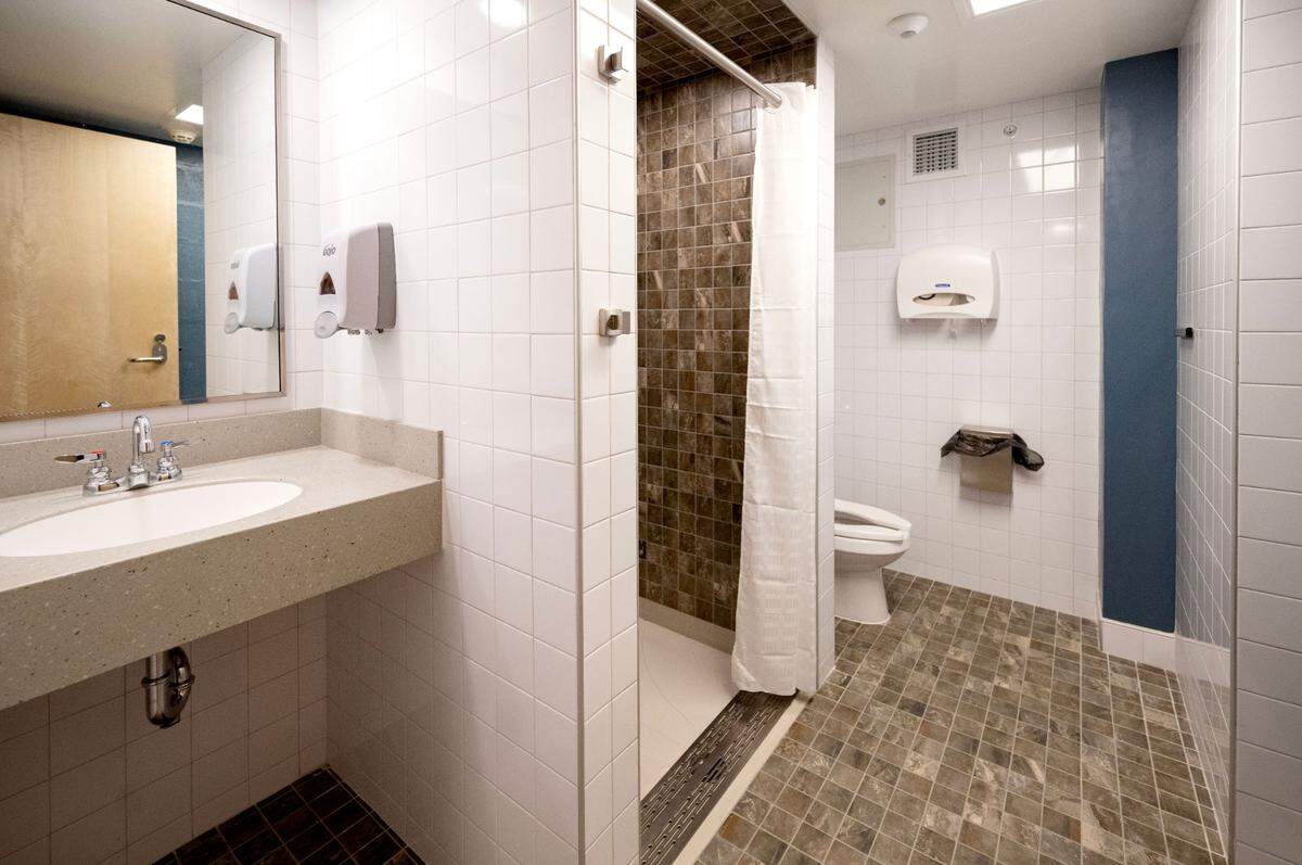 Inside one of the single use bathrooms in Hastings Hall that has a sink, shower and toilet for student privacy.