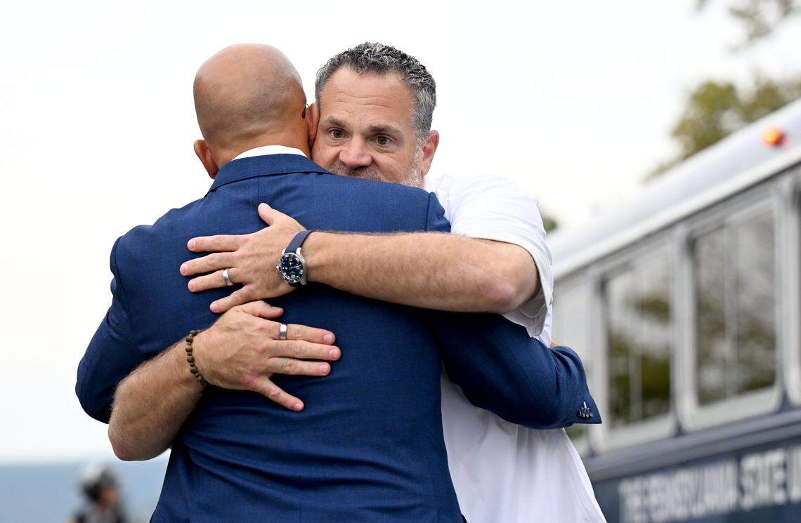 Penn State athletic director Pat Kraft hugs coach James Franklin as the team arrives at Beaver Stadium for the game against Oregon on Saturday, Sept. 27, 2025.  
