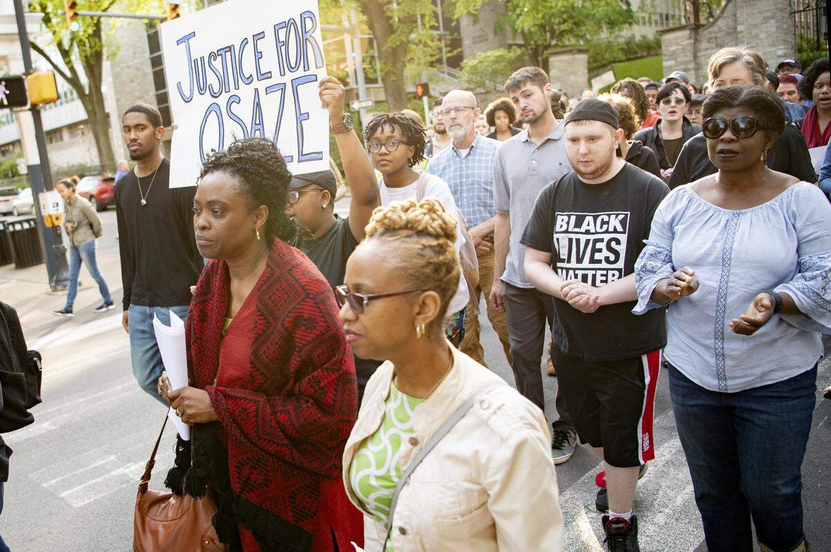 Iyun Osagie, Osaze Osagie’s mother, and crowd of community members walk up Allen Street in downtown State College to rally for justice on May 8.