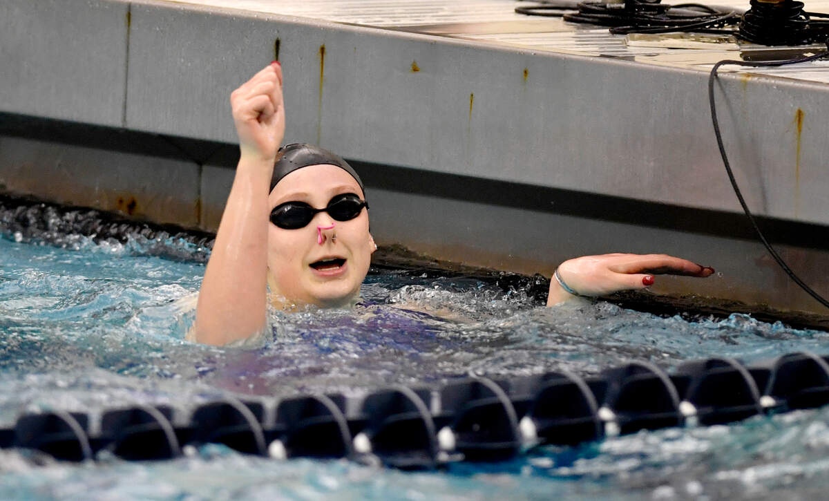 State College’s Jade Castro celebrates her second place finish in the 100 yard backstroke at the PIAA swimming championships at Bucknell on Thursday, March 17, 2022.