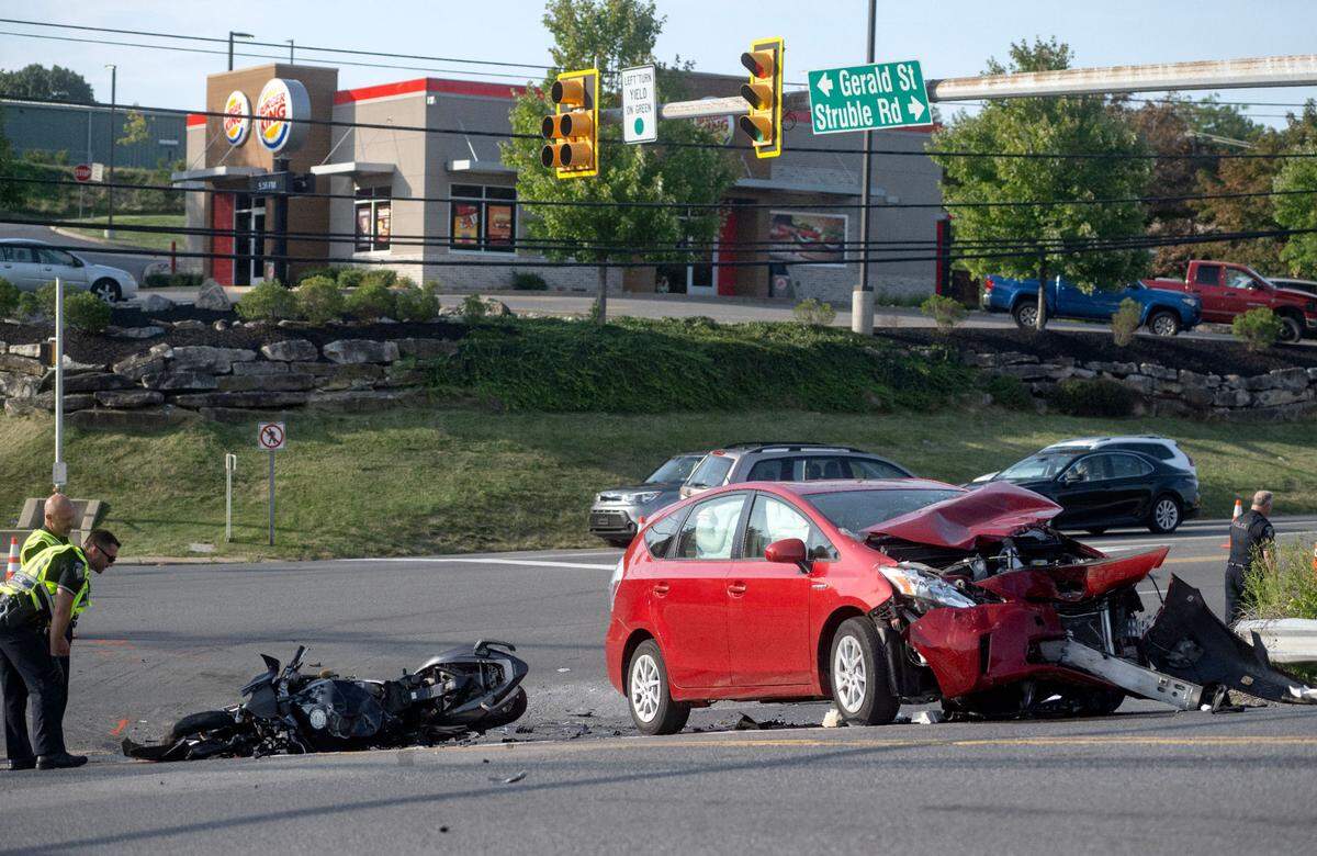 First responders on the scene of a crash between a car and a motorcycle on East College Avenue and Struble Road on Monday, Aug. 26, 2024.