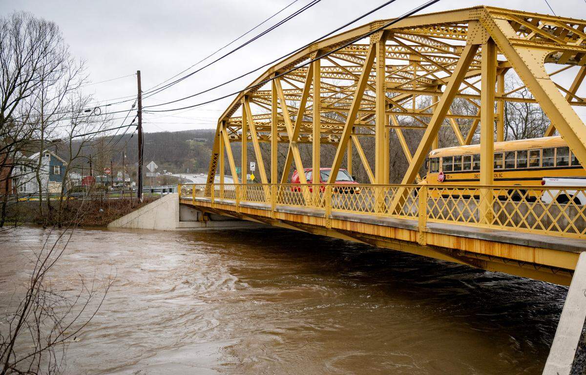 High water rushes under Veterans Bridge in Milesburg on Wednesday, April 3, 2024.