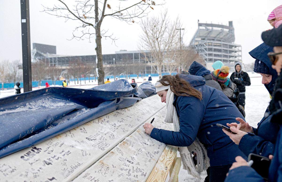 Penn State fans sign rows of bleachers from the West side of the stadium after the press box at Beaver Stadium was brought down on Saturday, Jan. 4, 2025.