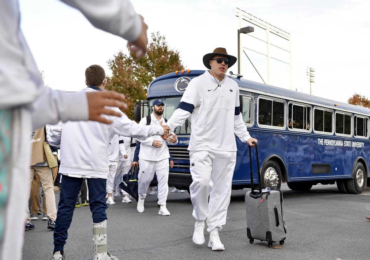 Penn State defensive tackle Robert Windsor high fives fans as he leads the team off the buses at Beaver Stadium for the game against Michigan on Saturday, Oct. 19, 2019.