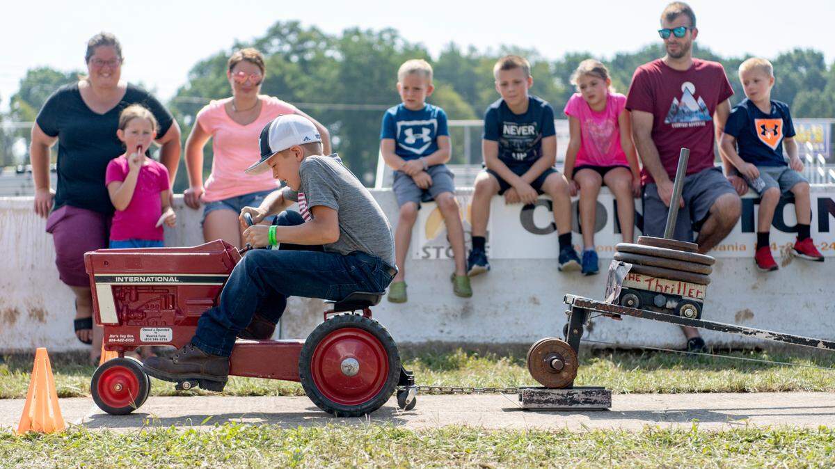 Tucker Deibler, 7, competes in the pedal tractor pull Tuesday at the Centre County Grange Fair.
