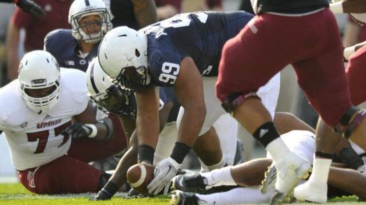 Penn State’s Austin Johnson picks up a fumble against Massachusetts on Saturday, Sept. 20, 2014.
