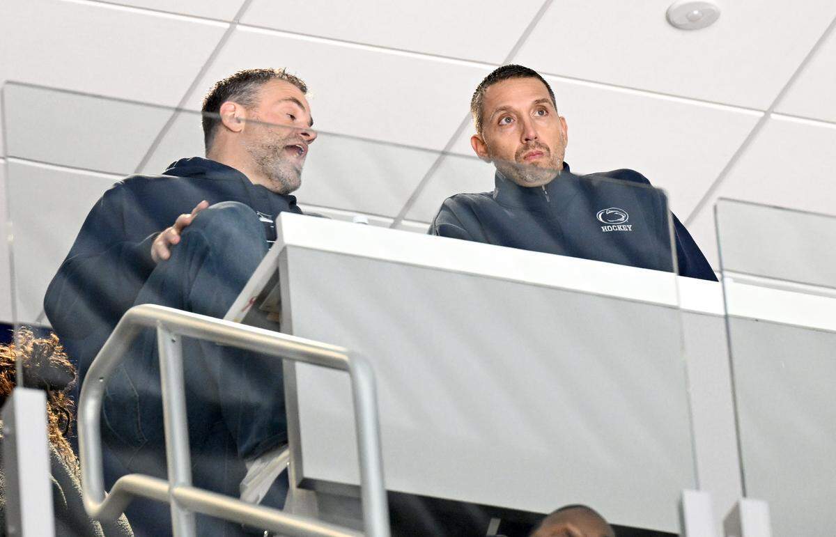 Penn State athletic director Pat Kraft talks with new football coach Matt Campbell during the men’s hockey game on Friday, Jan. 9, 2026 at Pegula Ice Arena.