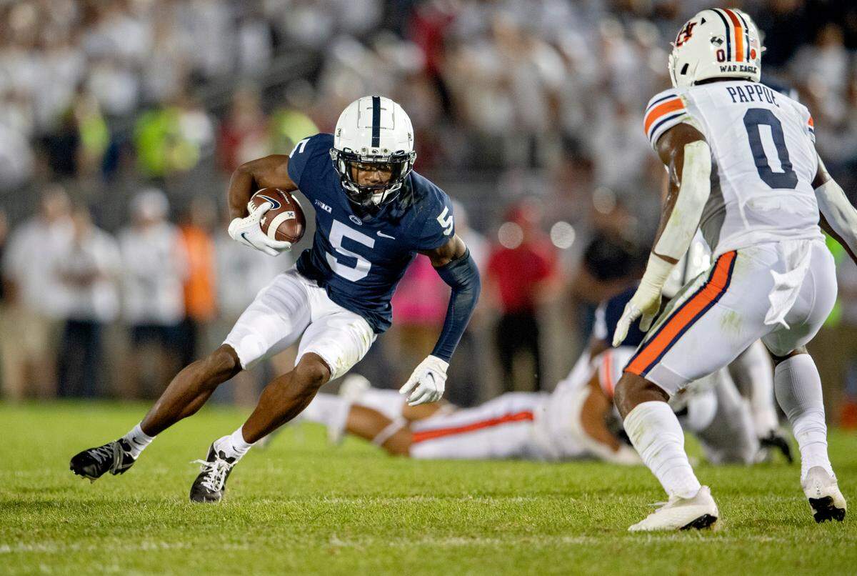 Penn State wide receiver Jahan Dotson makes a catch and looks to cut past Auburn defenders during the game.