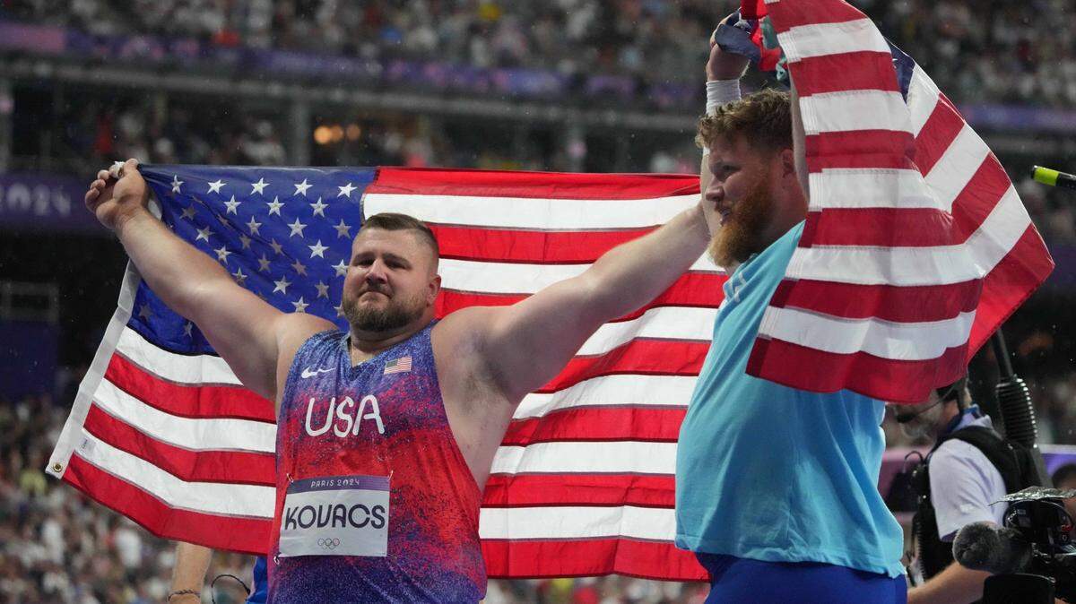 Aug 3, 2024; Paris, FRANCE; Joe Kovacs (USA) and Ryan Crouser (USA) celebrate after the men's shot put final during the Paris 2024 Olympic Summer Games at Stade de France. Mandatory Credit: Kirby Lee-USA TODAY Sports