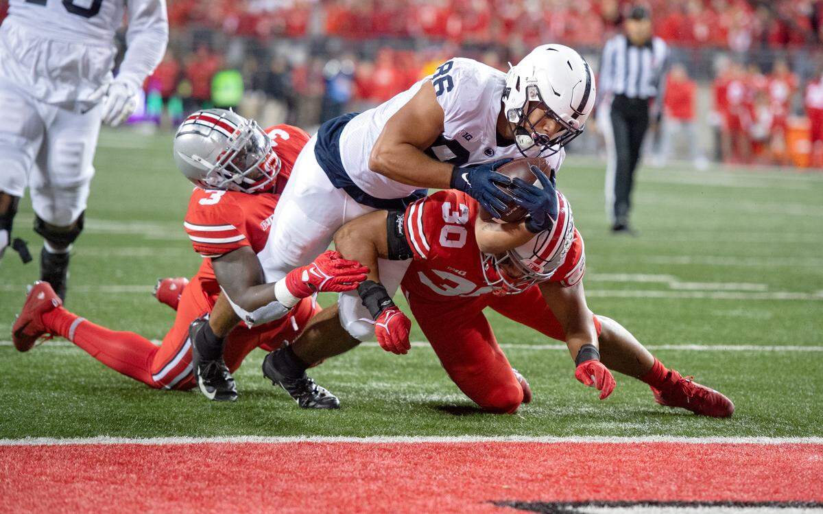Ohio State defenders can’t stop Penn State tight end Brenton Strange as he dives into the end zone for a touchdown in the first quarter of the game on Saturday, Oct. 30, 2021 at Ohio Stadium.
