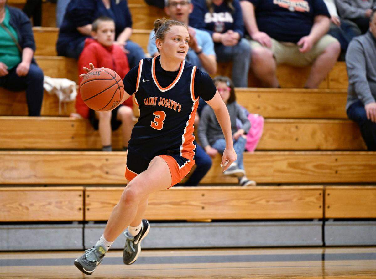 Saint Joseph’s Catholic Academy’s Naomi Crispin dribbles from DuBois Central Catholic defenders in the fourth quarter of the game on Wednesday, March, 12, 2025 at Bald Eagle Area High School.