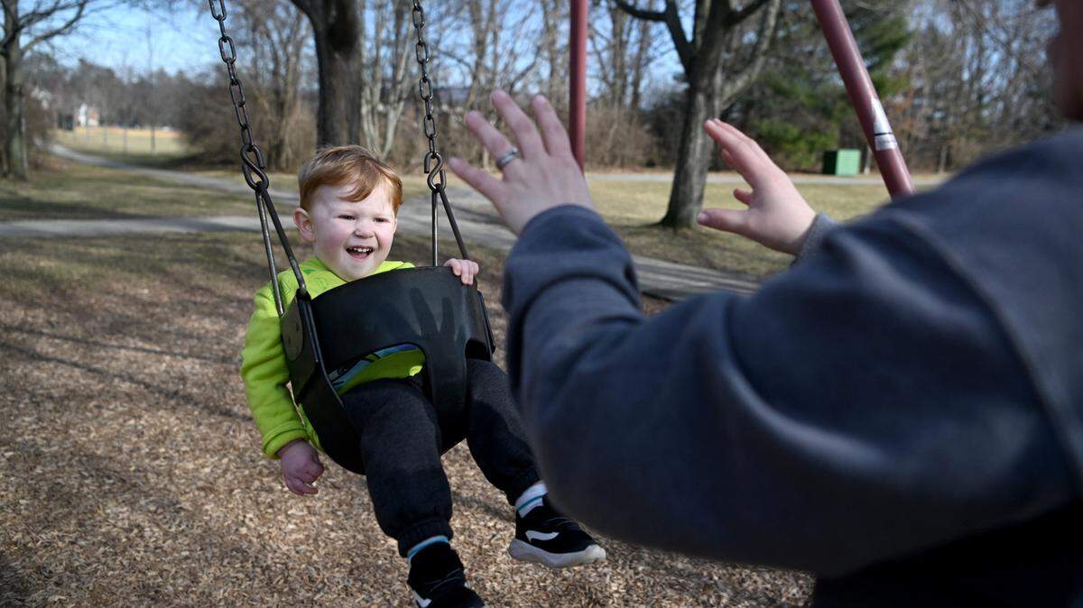 Two and a half year old Robert Schilling laughs as he gets pushed on the swings Tuesday at Tudek Park.