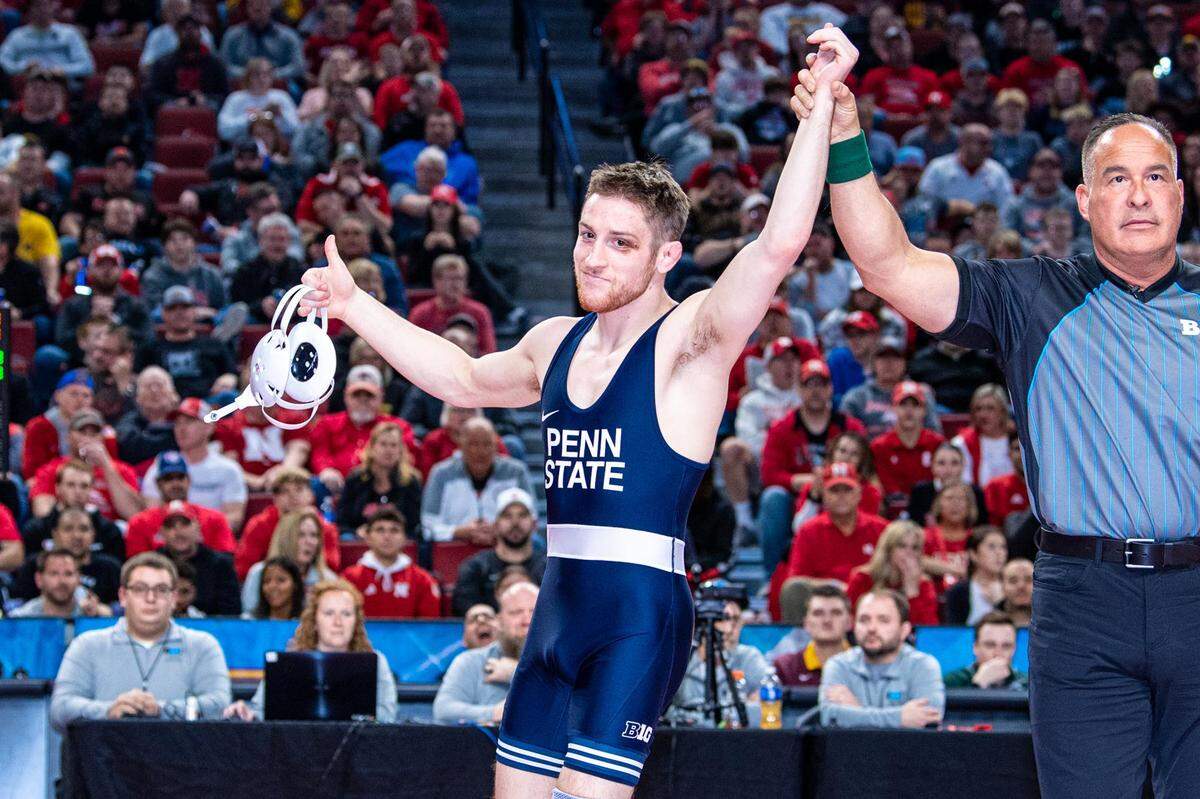 Penn State’s Nick Lee has his hand raised after receiving a medical forfeit in the 141 pounds finals of the Big Ten Championships on Sunday, March 6, 2022 in Lincoln, Neb. Lee was supposed to wrestle Iowa’s Jaydin Eierman.