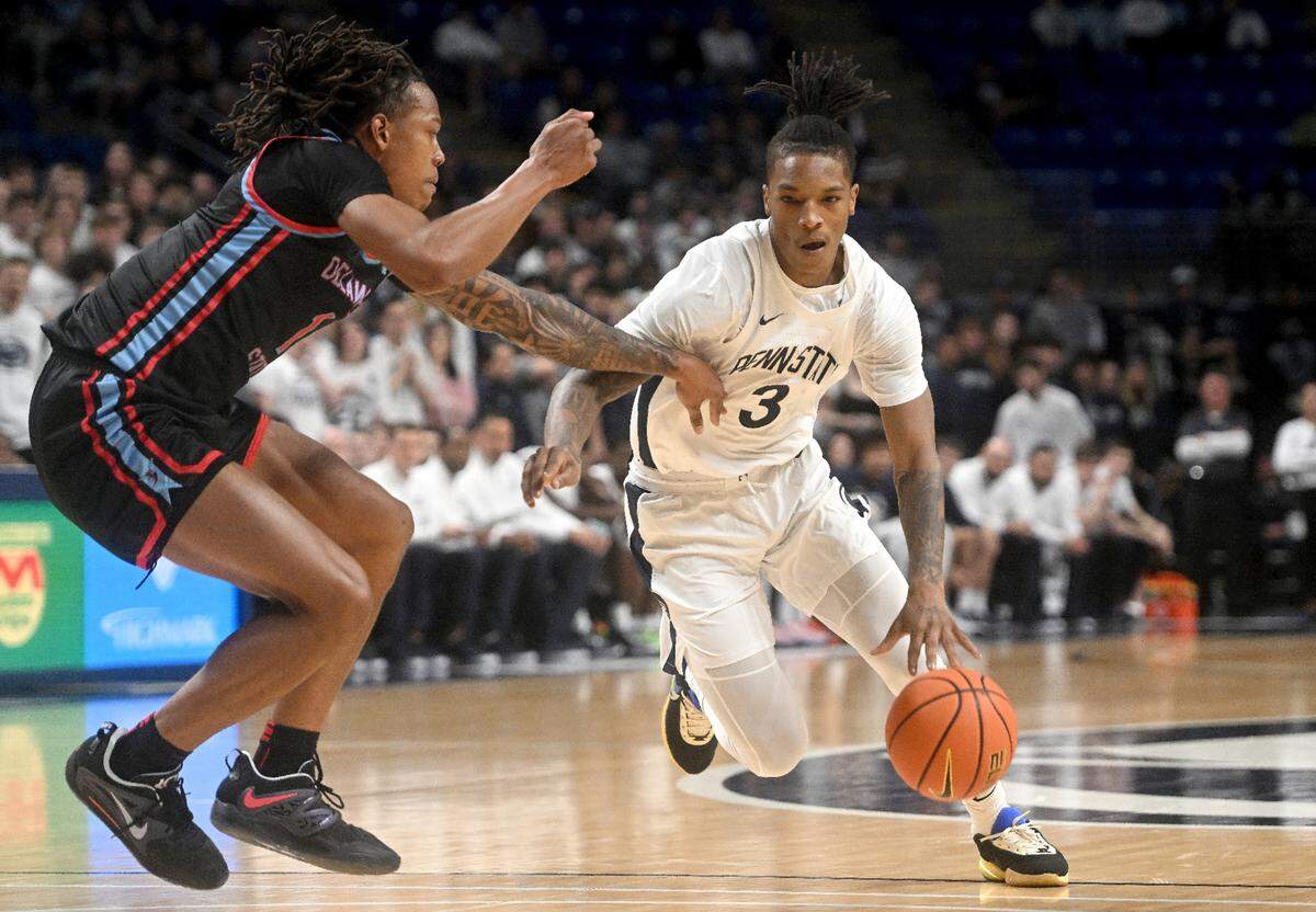 Penn State’s Nick Kern Jr. dribbles around a Delaware State defender during the game on Monday, Nov. 6, 2023.