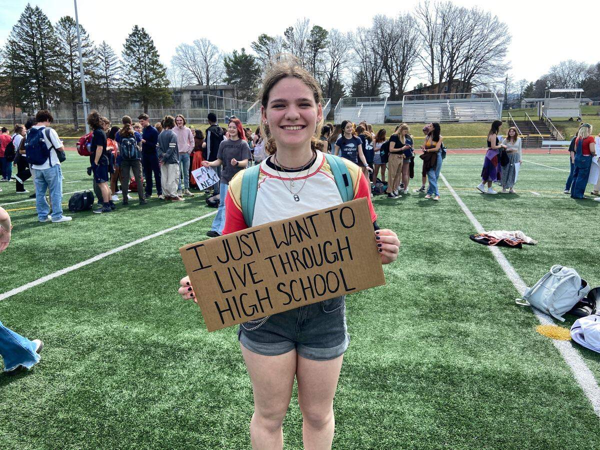 Senior Nat Pearson holds up a sign she made for State High’s walkout to protest gun violence on Wednesday.