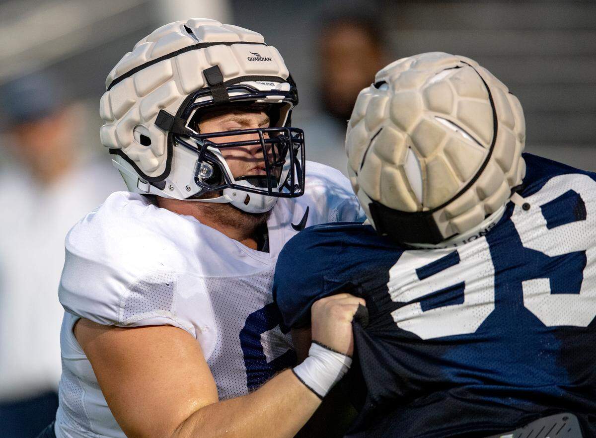 Penn State offensive lineman Eric Wilson blocks Penn State defensive tackle Coziah Izzard during practice on Wednesday, Aug. 25, 2021 in Beaver Stadium.