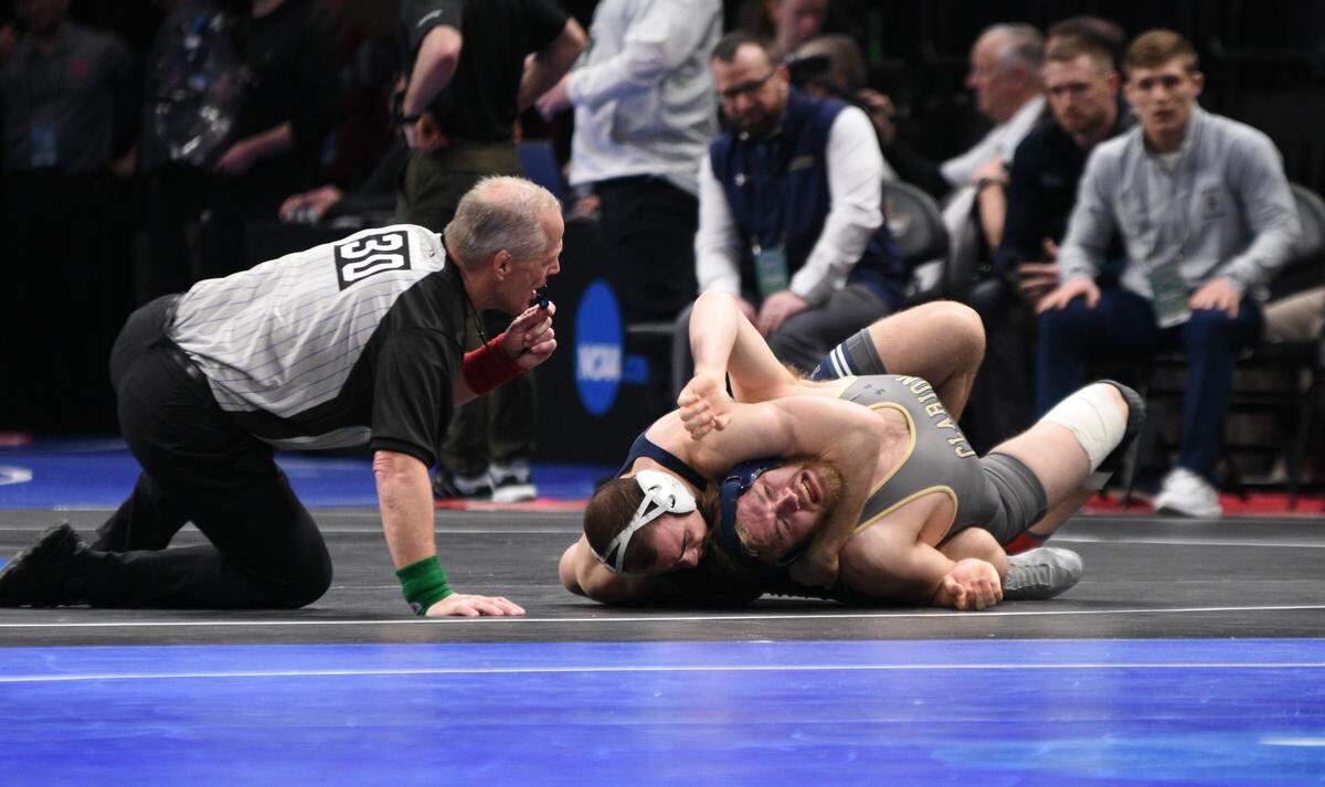 Penn State’s Max Dean collects nearfall points on Clarion’s Will Feldkamp in their 197-pound first round match of the NCAA Championships on Thursday, March 17, 2022 at Little Caesar’s Arena in Detroit. Dean earned a 16-1 technical fall in 4:40.